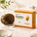 Sabonete de Enxofre GHDerma 90g: caixa laranja ao lado da barra de sabonete com espuma, sobre bancada clara com folhagem
